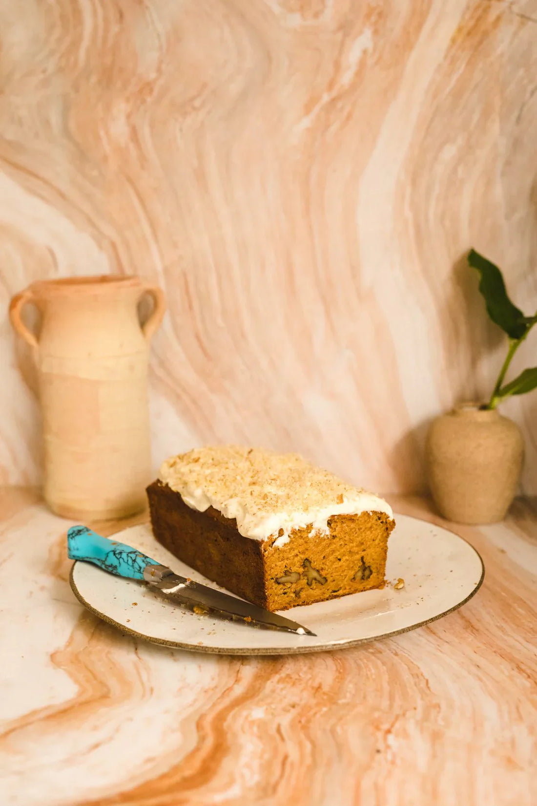Spiced carrot loaf with maple cream cheese frosting & crushed walnuts