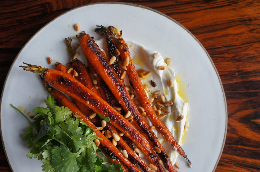 Harissa roasted carrots with yogurt, pine nuts and fresh herbs