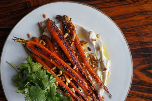 Harissa roasted carrots with yogurt, pine nuts and fresh herbs