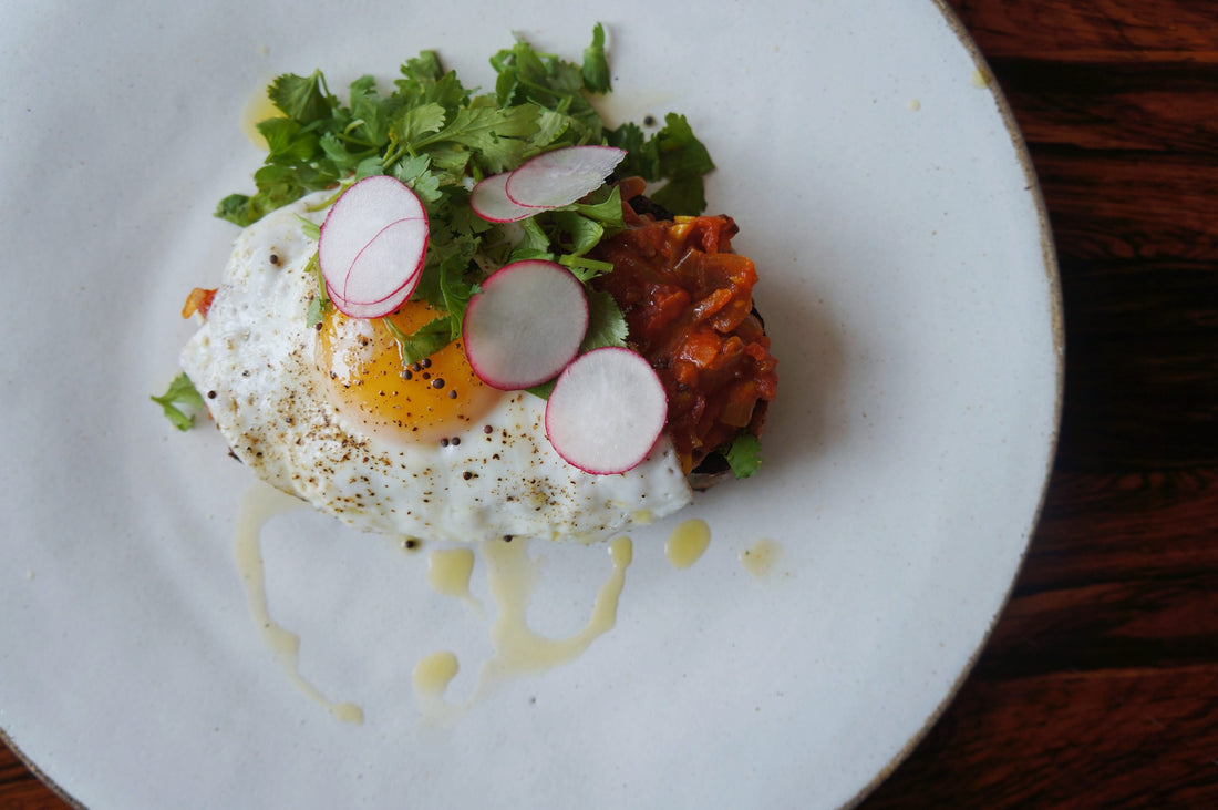 Curried Tomato Jam Toast with A Fried Egg, Mustard Seeds & Cilantro